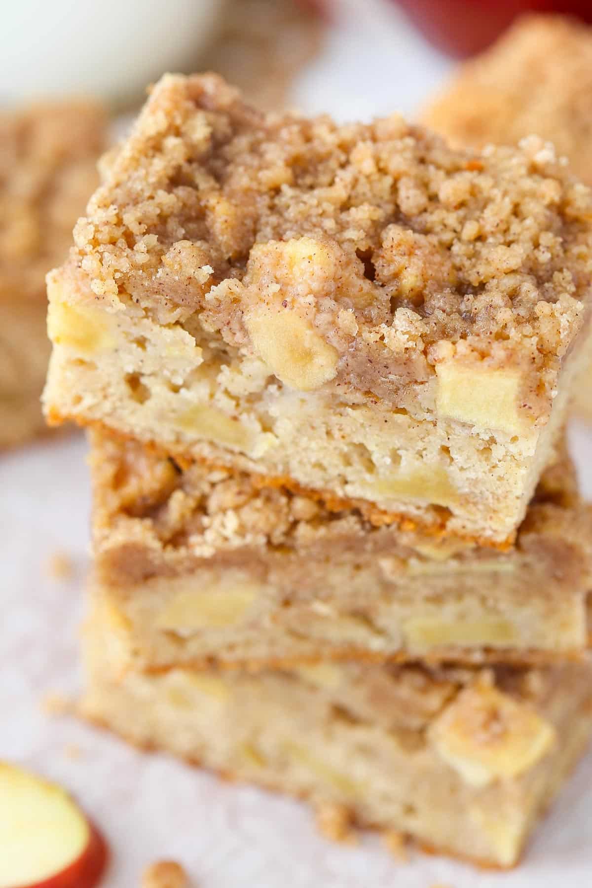 Top view of three apple streusel bars stacked one on top of the other.
