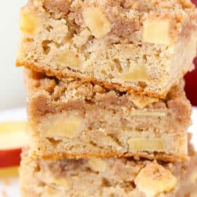 Close up of three apple streusel bars stacked one on top of the other.