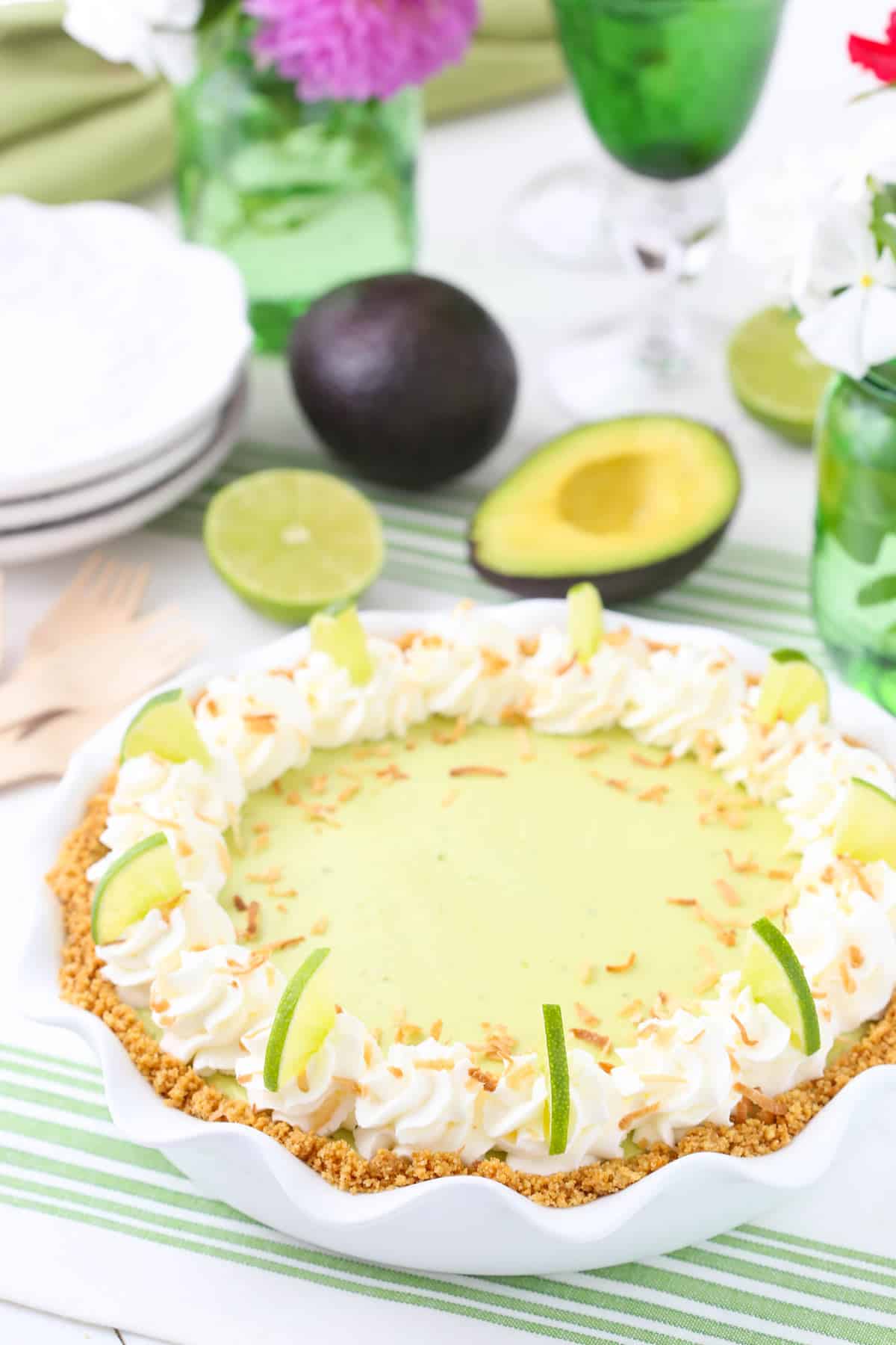 An avocado key lime pie in a white ruffled pie pan.