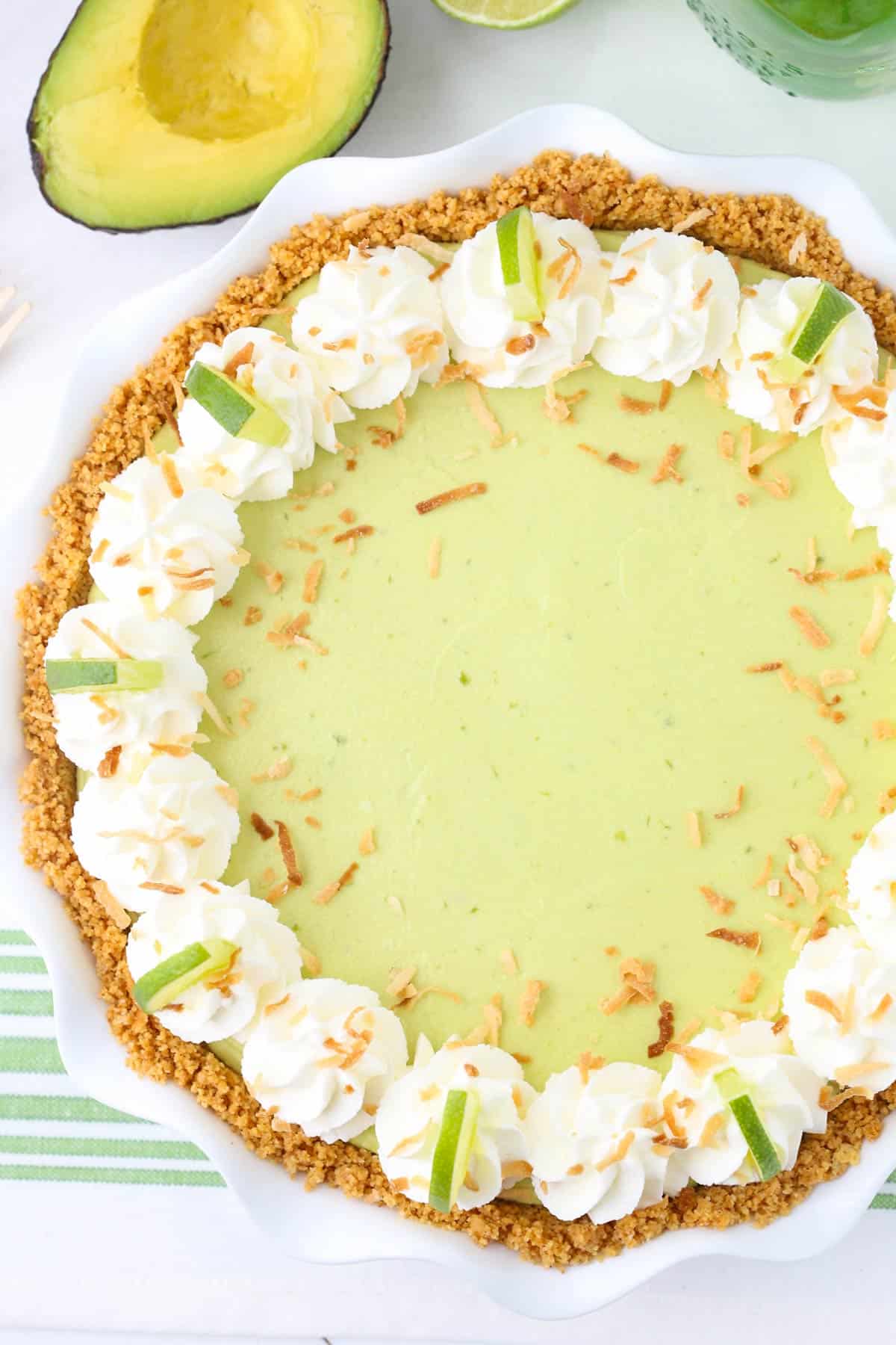 Top view of an avocado key lime pie in a white ruffled pie pan.
