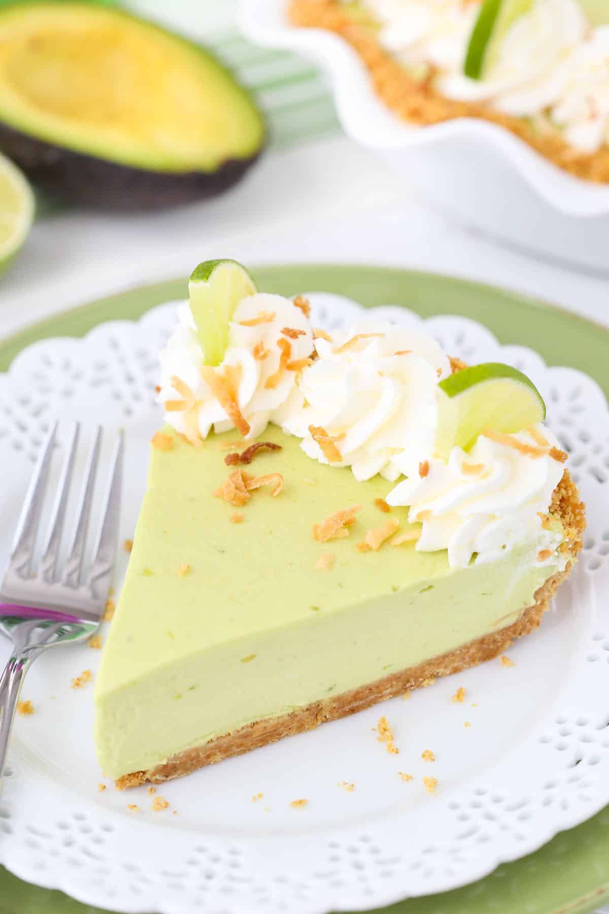 Close up of a slice of avocado key lime pie on a small white plate.