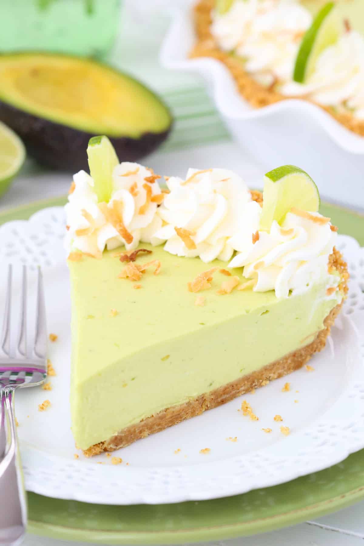 Close up of an avocado key lime pie on a small white plate.