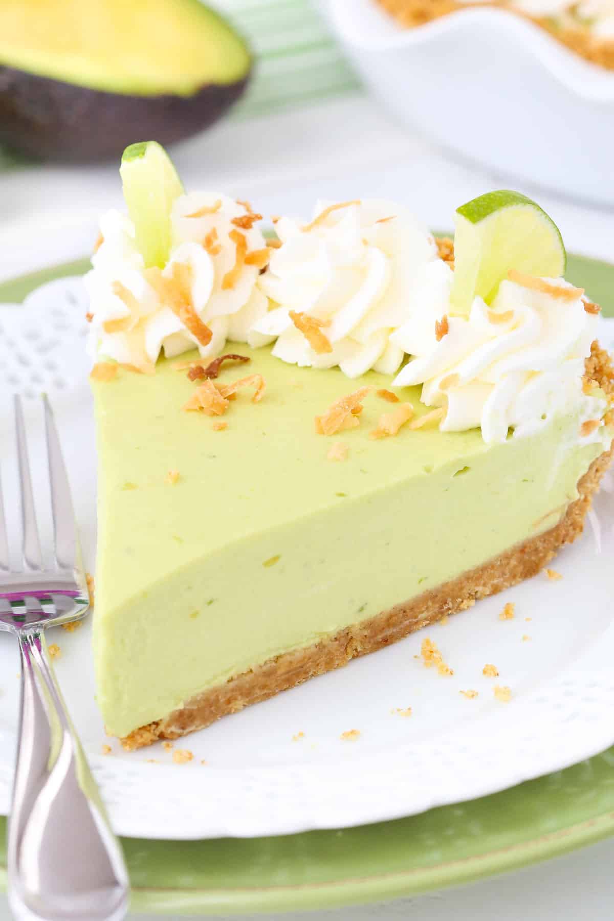 Close up of a slice of avocado key lime pie on a small white plate.