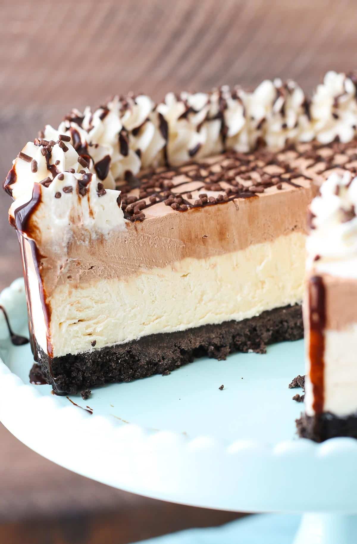 A frozen Irish cream mousse cake with a slice removed to show interior layers.
