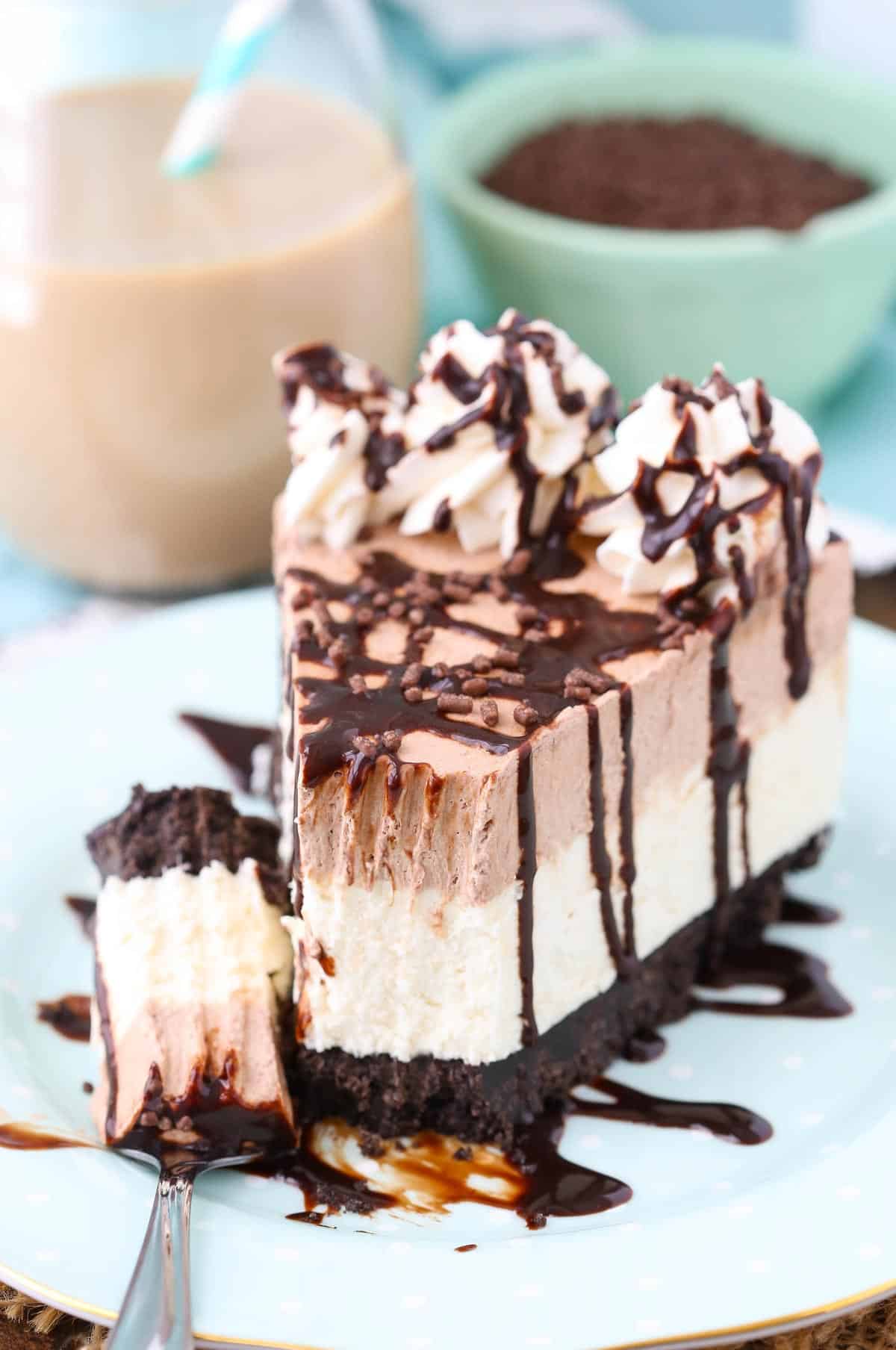 A slice of frozen Irish cream mousse cake with a bite removed on a fork.