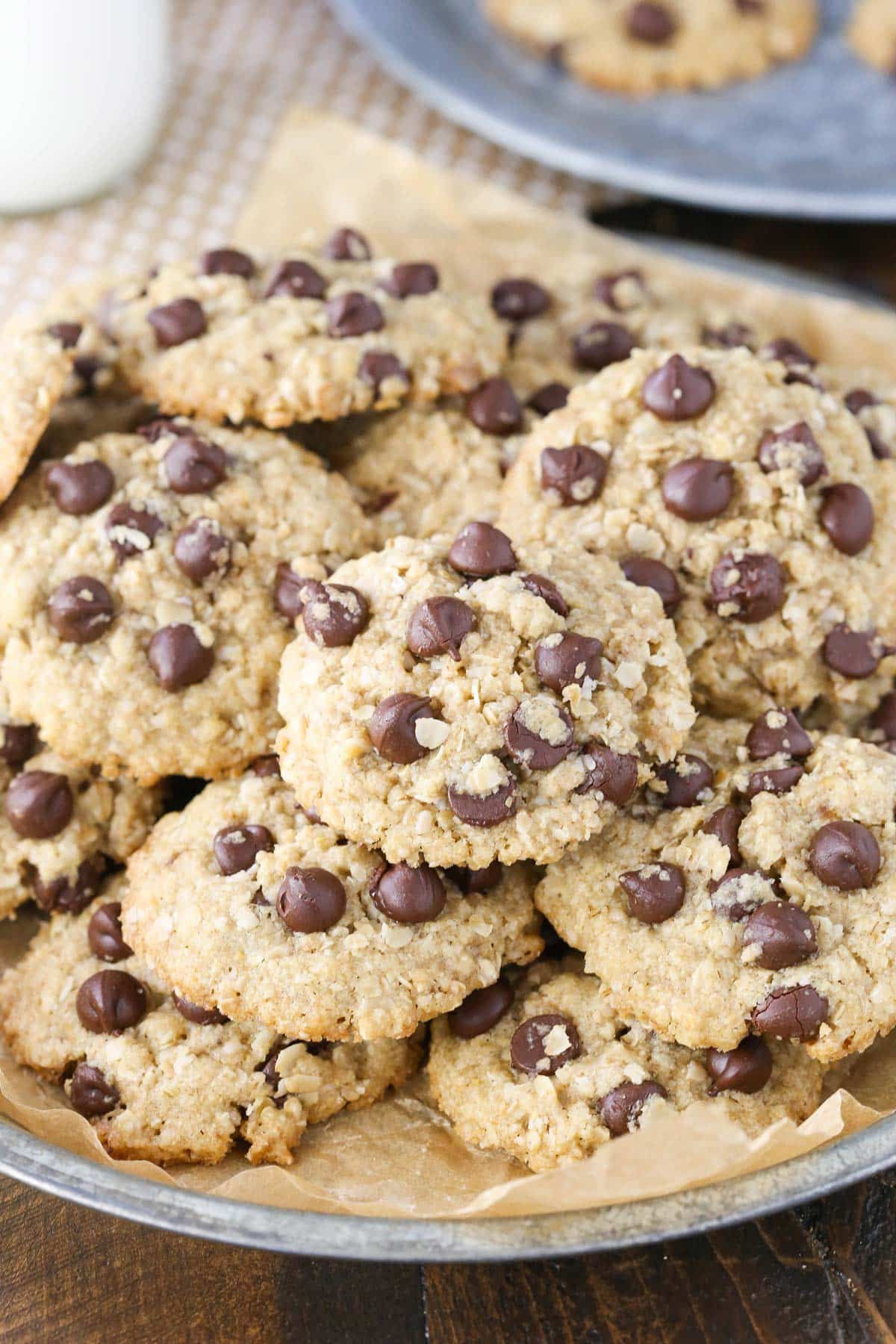 A silver tray piled with gluten and dairy free oatmeal chocolate chip cookies.
