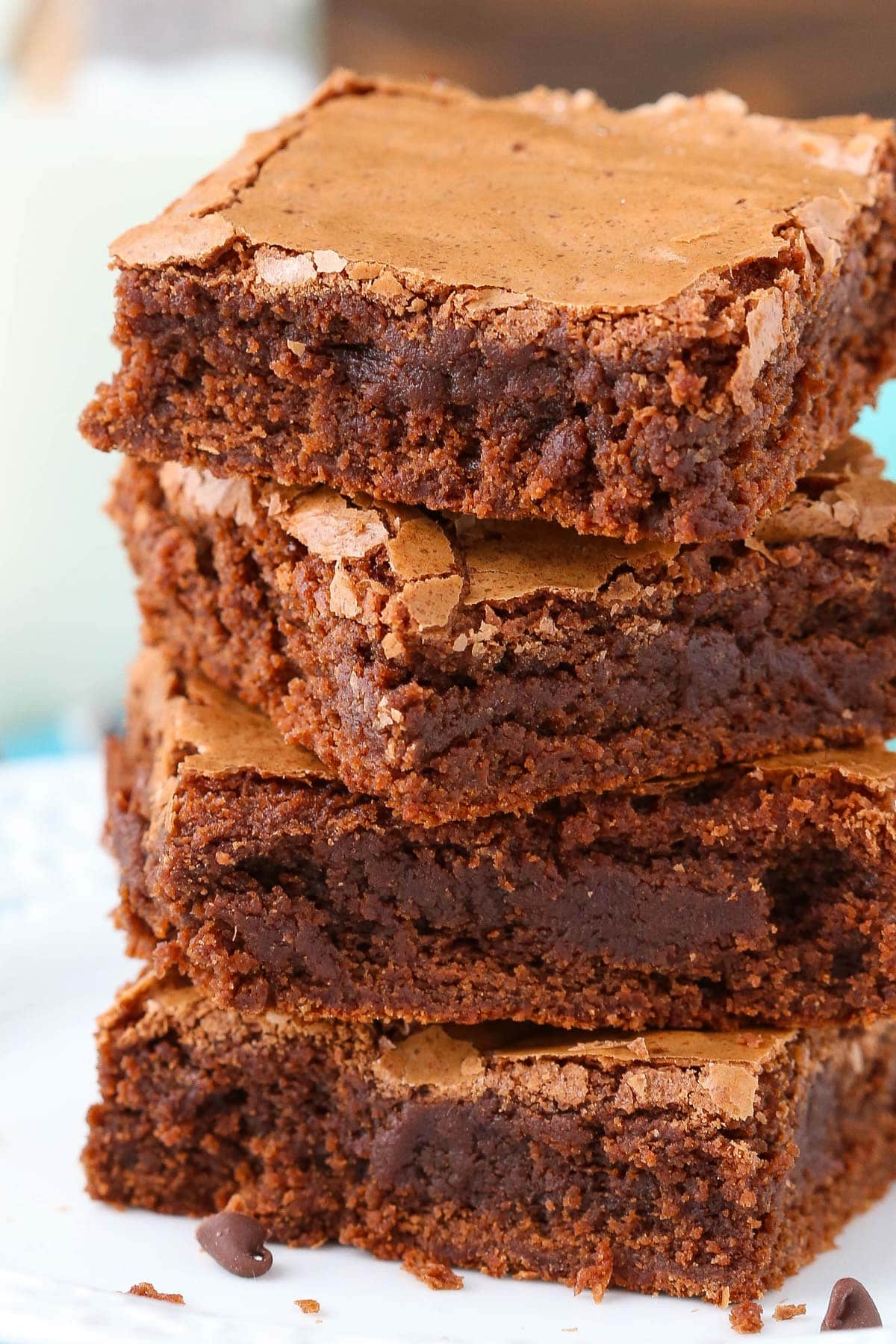 Close up of a stack of 4 fudgy brownies.