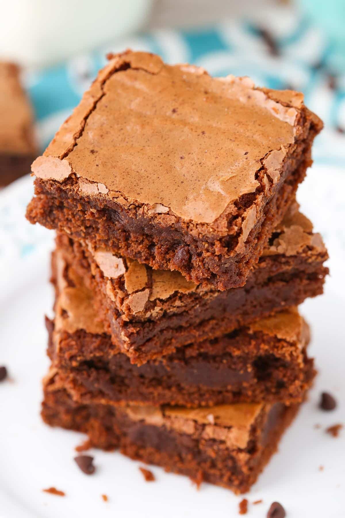Top view of 4 fudgy brownies stacked one on top of the other.
