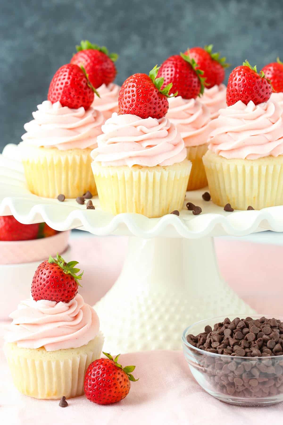 Neapolitan cupcakes on a white cake stand.