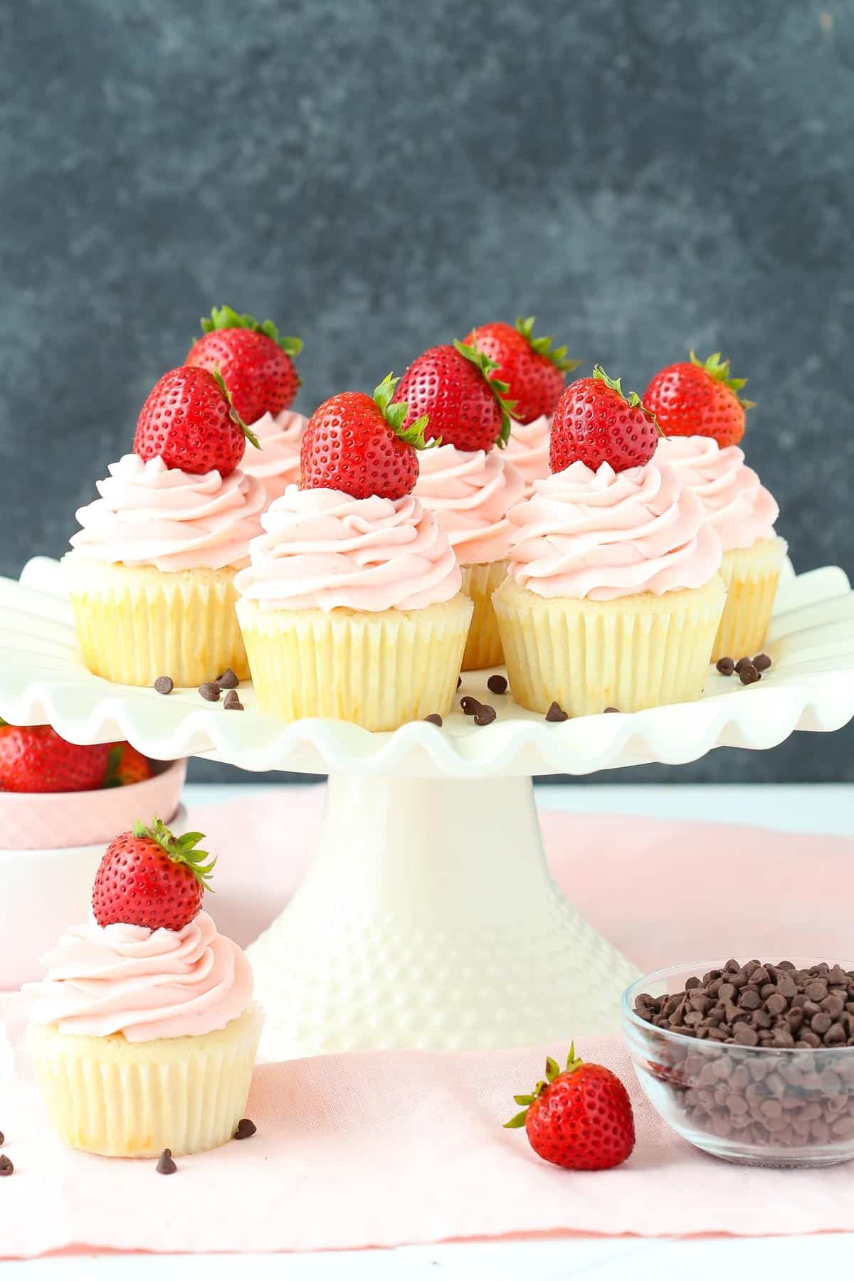 A cake stand covered with neapolitan cupcakes.
