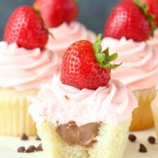 Close up of a neapolitan cupcake with a bite taken out of it.