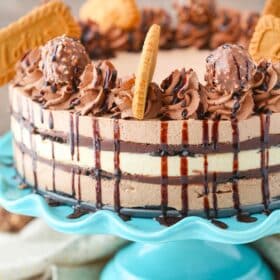 Close up of a layered Nutella Biscoff icebox cake on a teal cake stand.