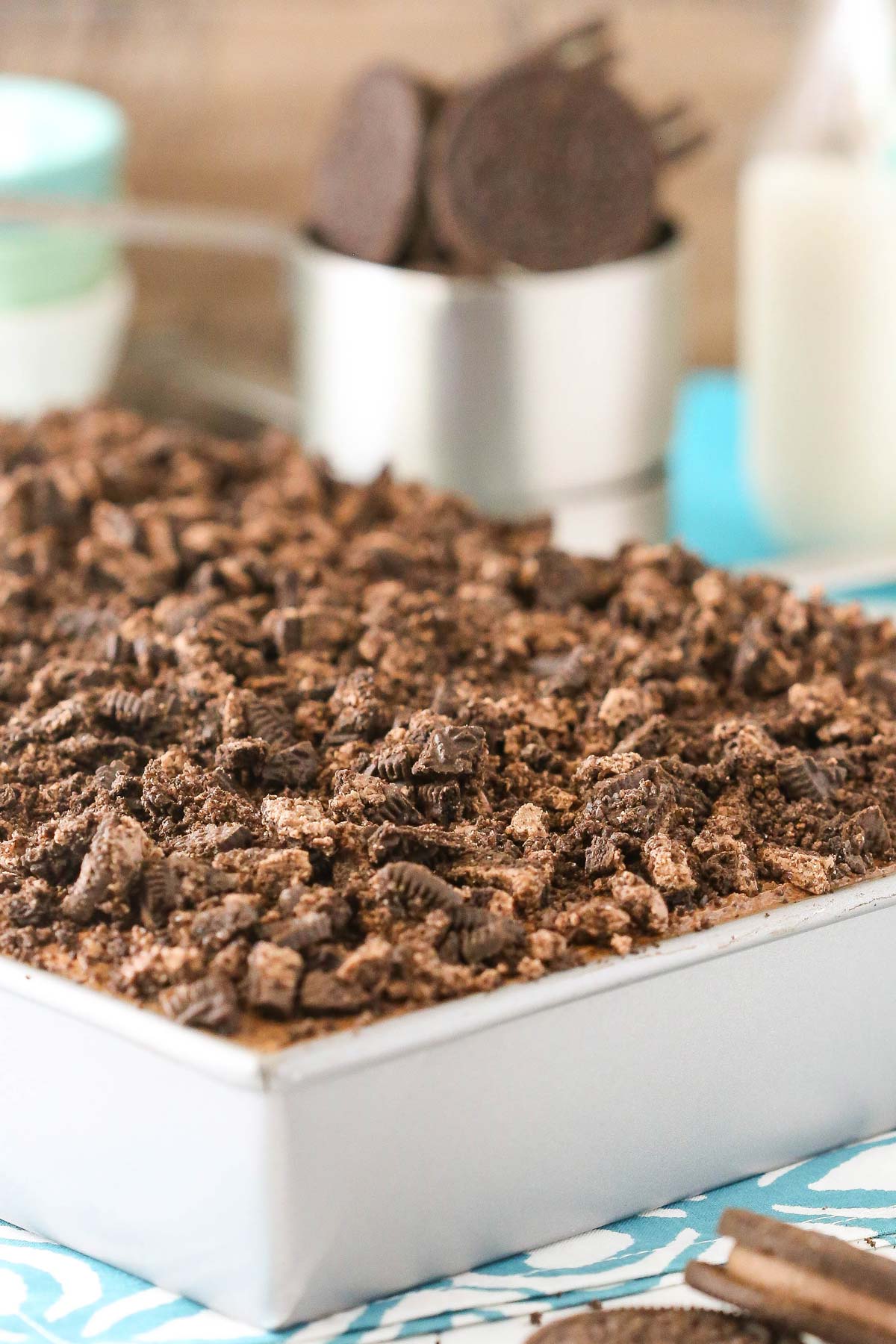 A silver cake pan filled with Oreo chocolate poke cake.