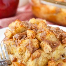A slice of overnight cinnamon apple French toast casserole on a small plate.