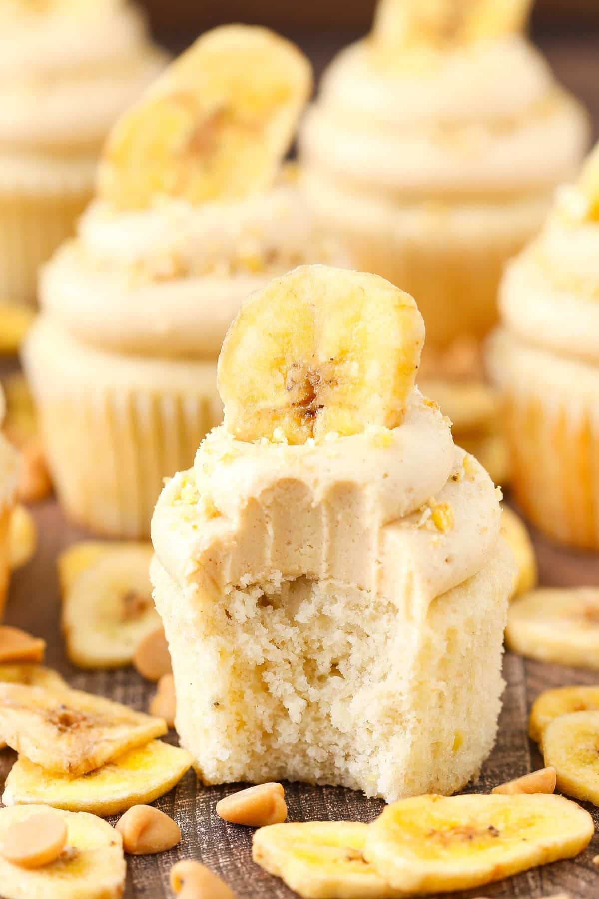 A peanut butter banana cupcake with a bite taken out of it.