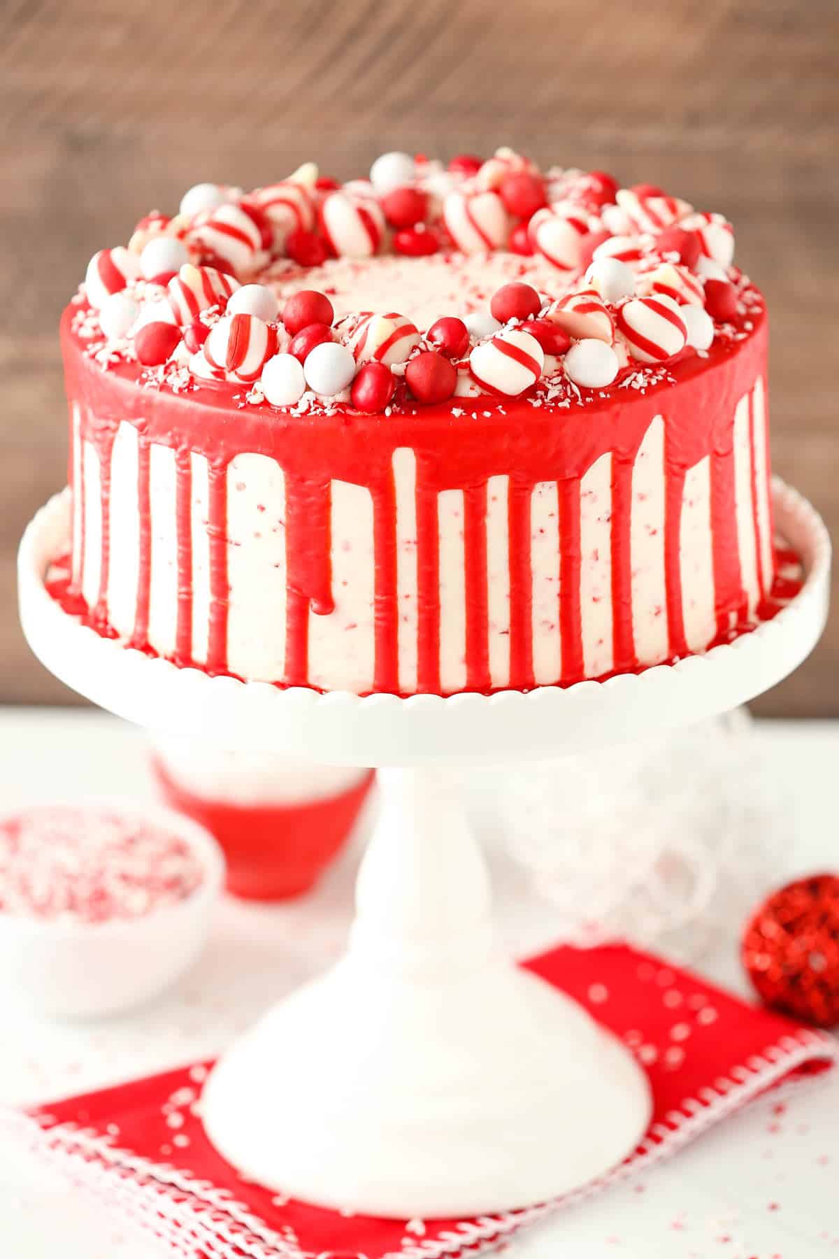 A peppermint chip layer cake on a tall white cake stand.