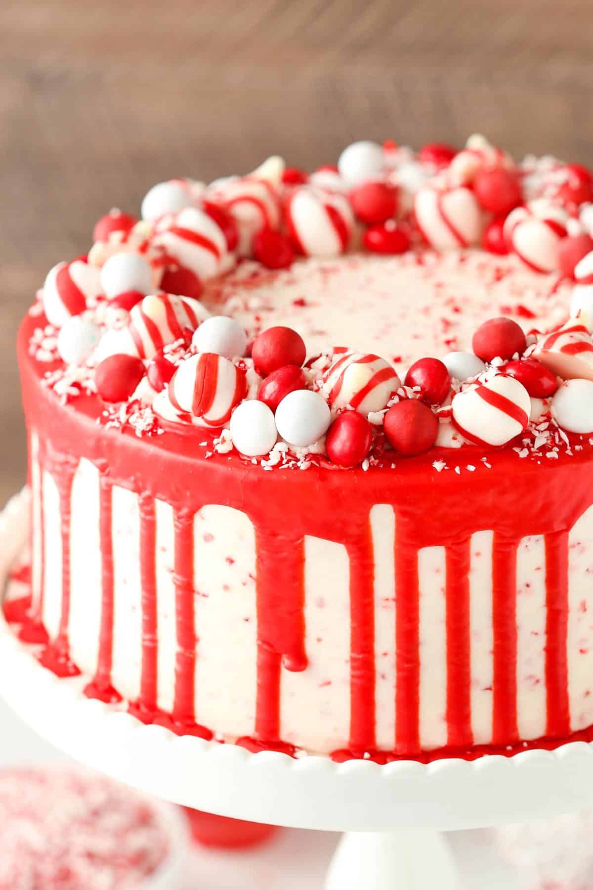 Close up of a peppermint chip layer cake on a white cake stand.