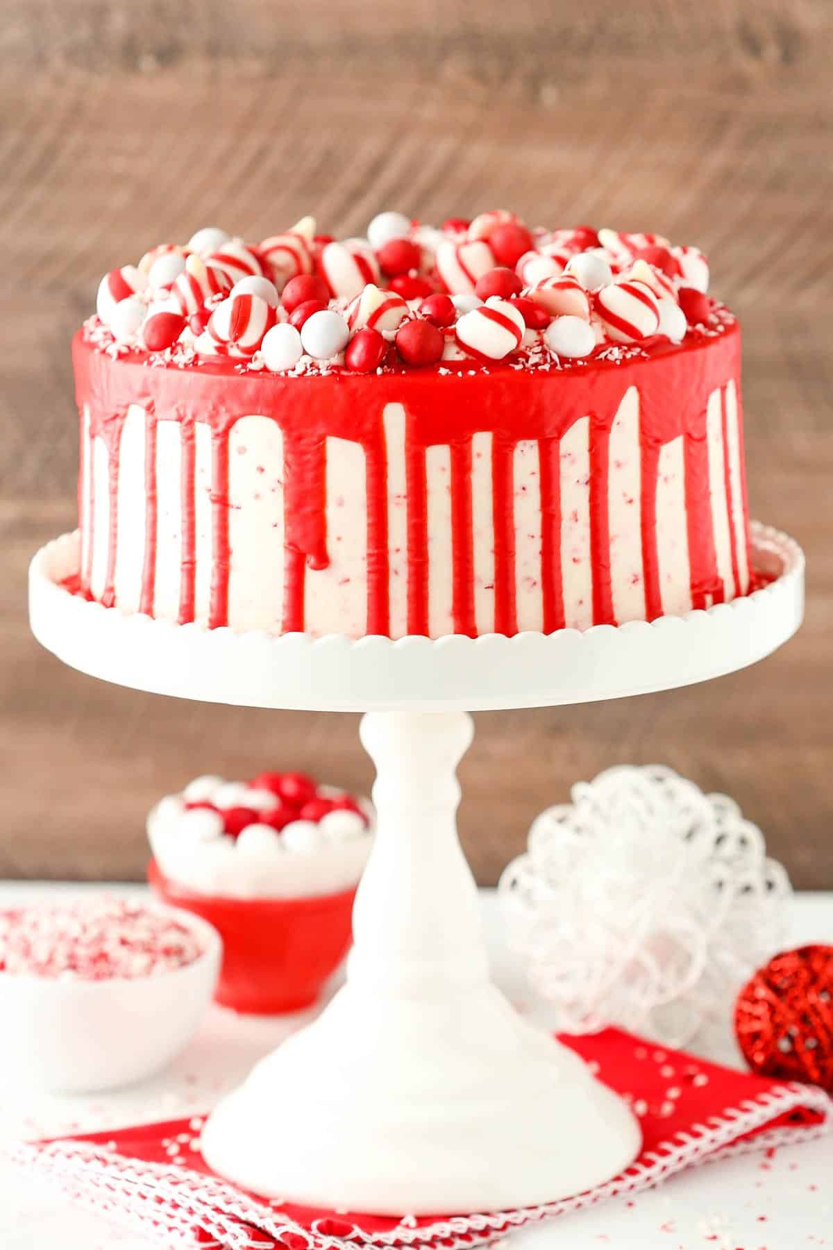 A peppermint chip layer cake on a tall white cake stand.