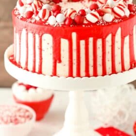 A peppermint chip layer cake on a tall white cake stand.