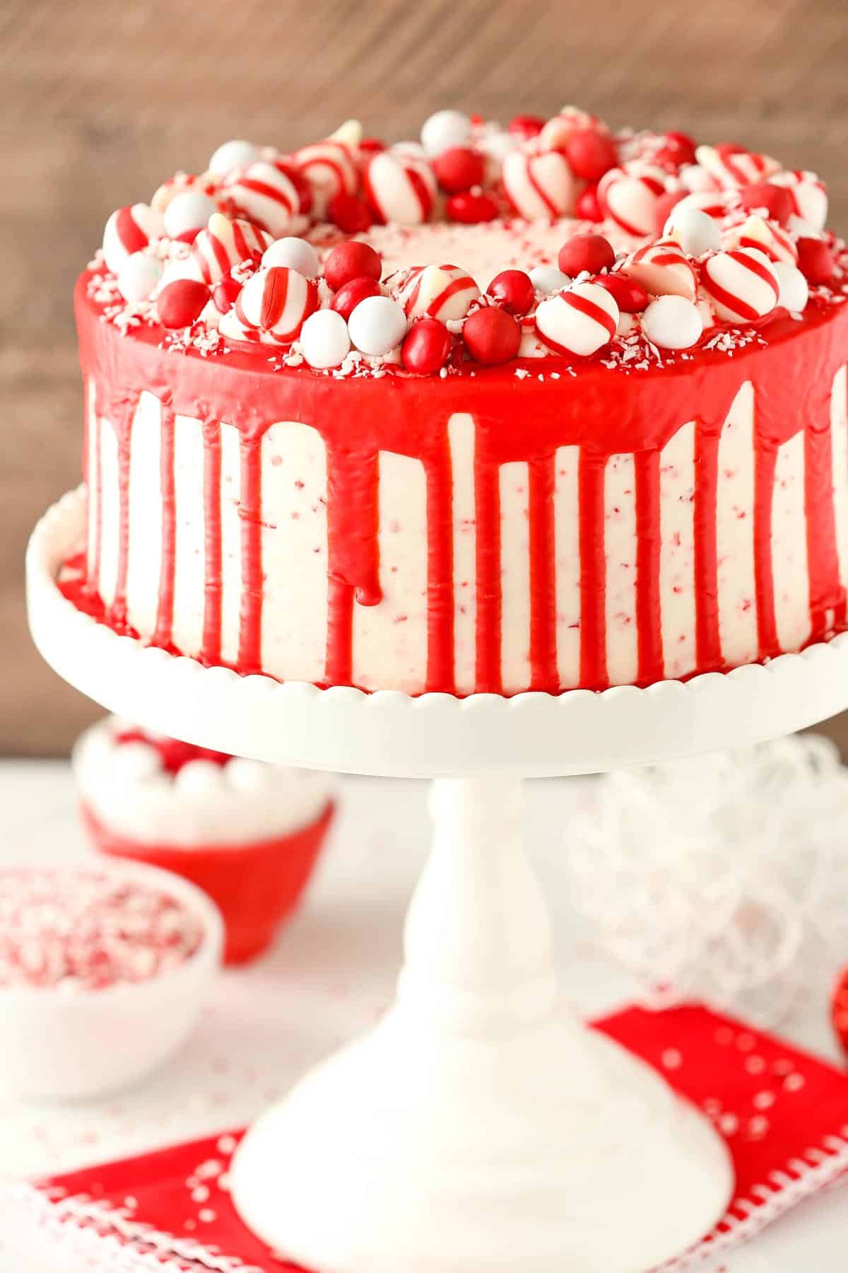 A peppermint chip layer cake on a tall white cake stand.