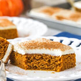 A pumpkin bar on a plate with a bite taken from it.