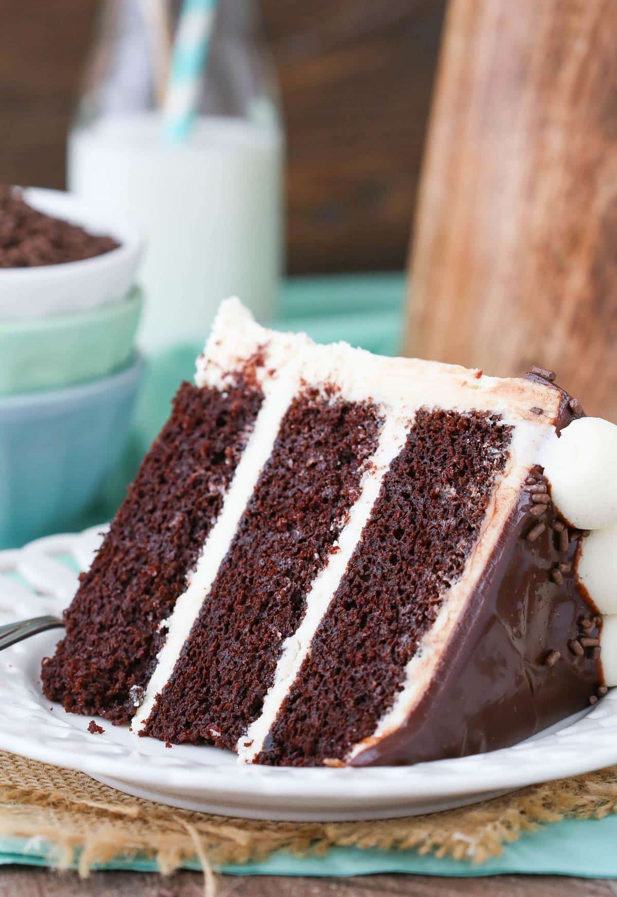 Close up of a slice of Baileys chocolate cake on a white plate.