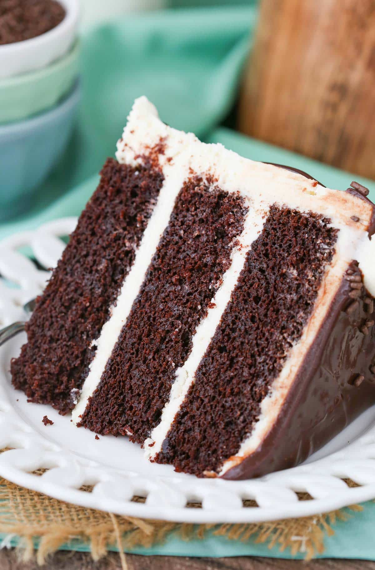 Close up of a slice of Baileys chocolate cake on a white plate.