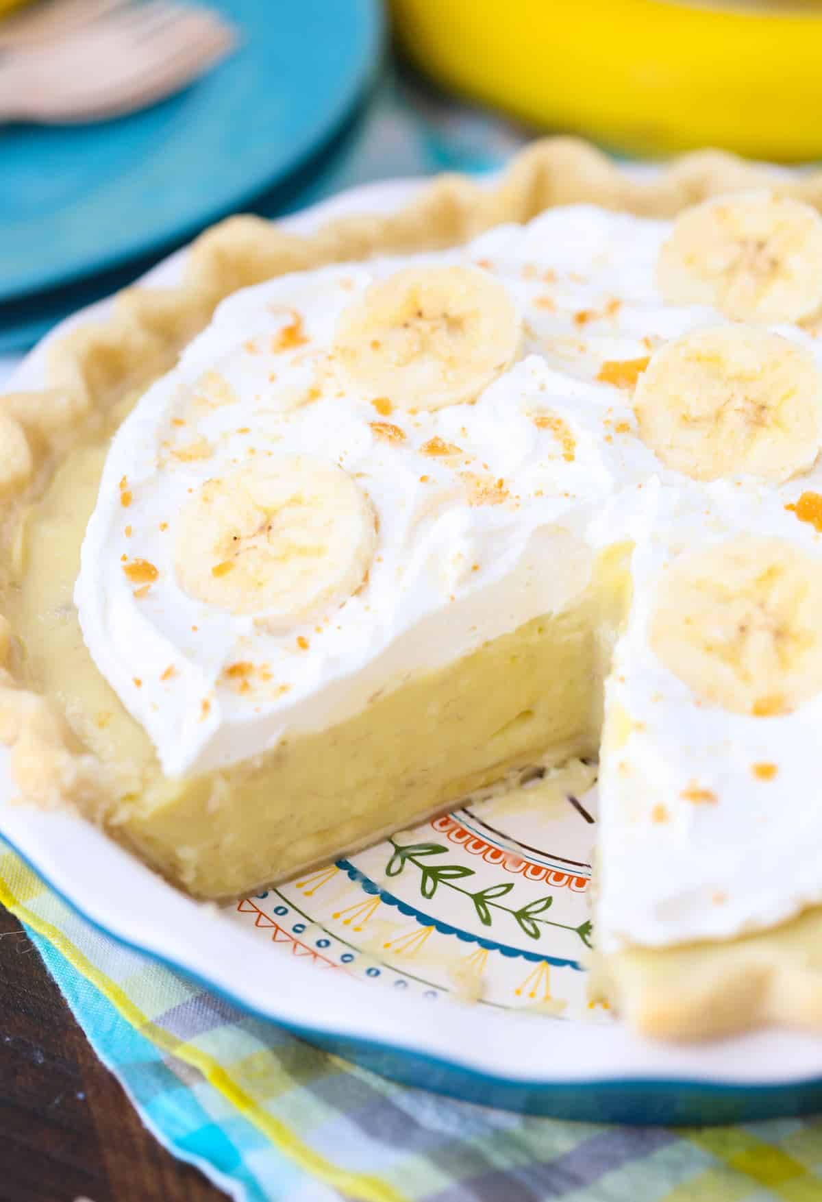 A banana cream pie with a slice removed to show layers.