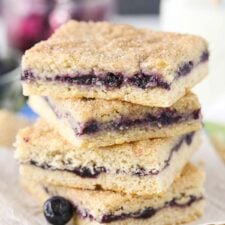 Close up of a stack of 4 blueberry jam cake bars.