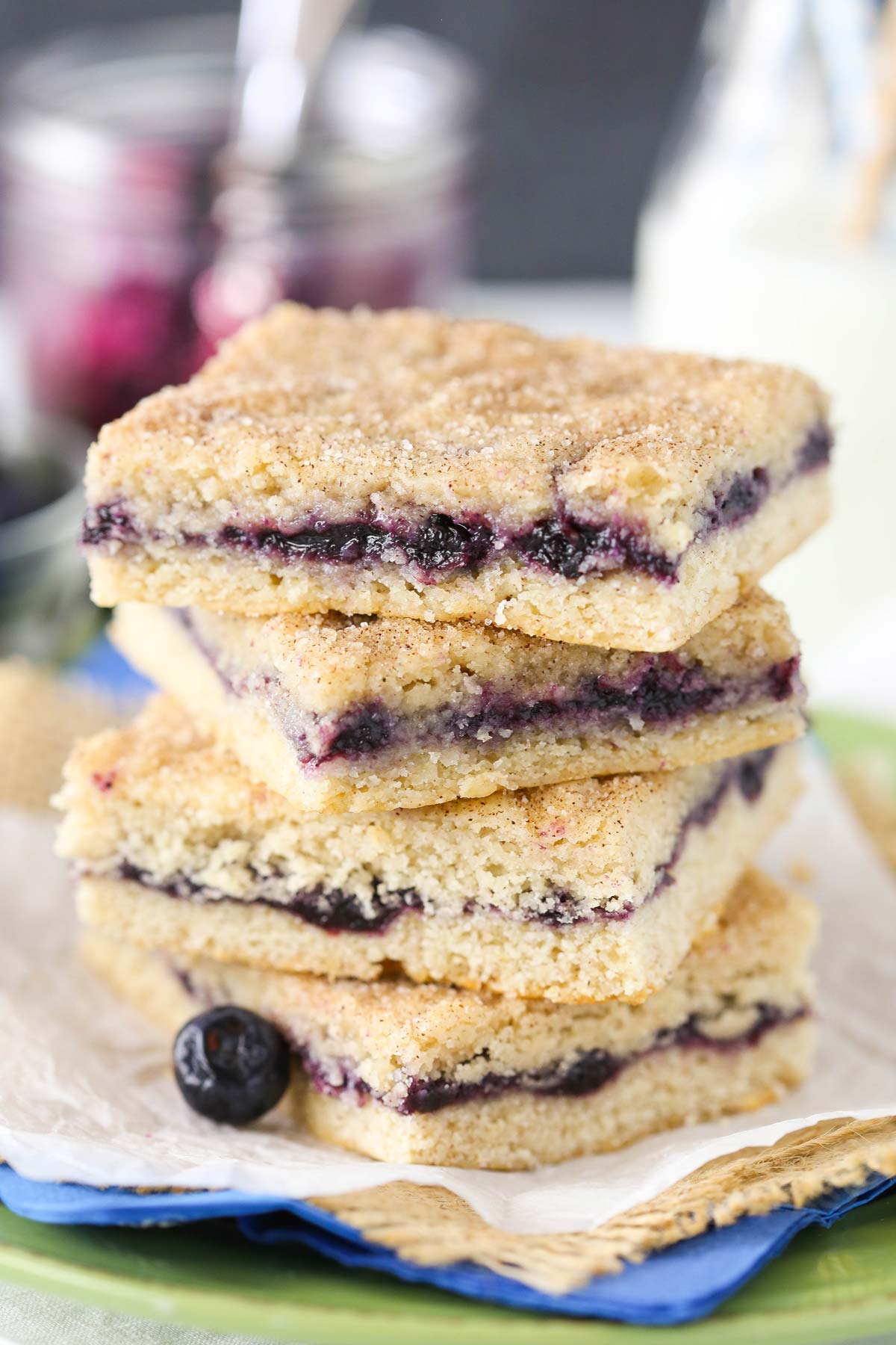 Close up of a stack of 4 blueberry jam cake bars.
