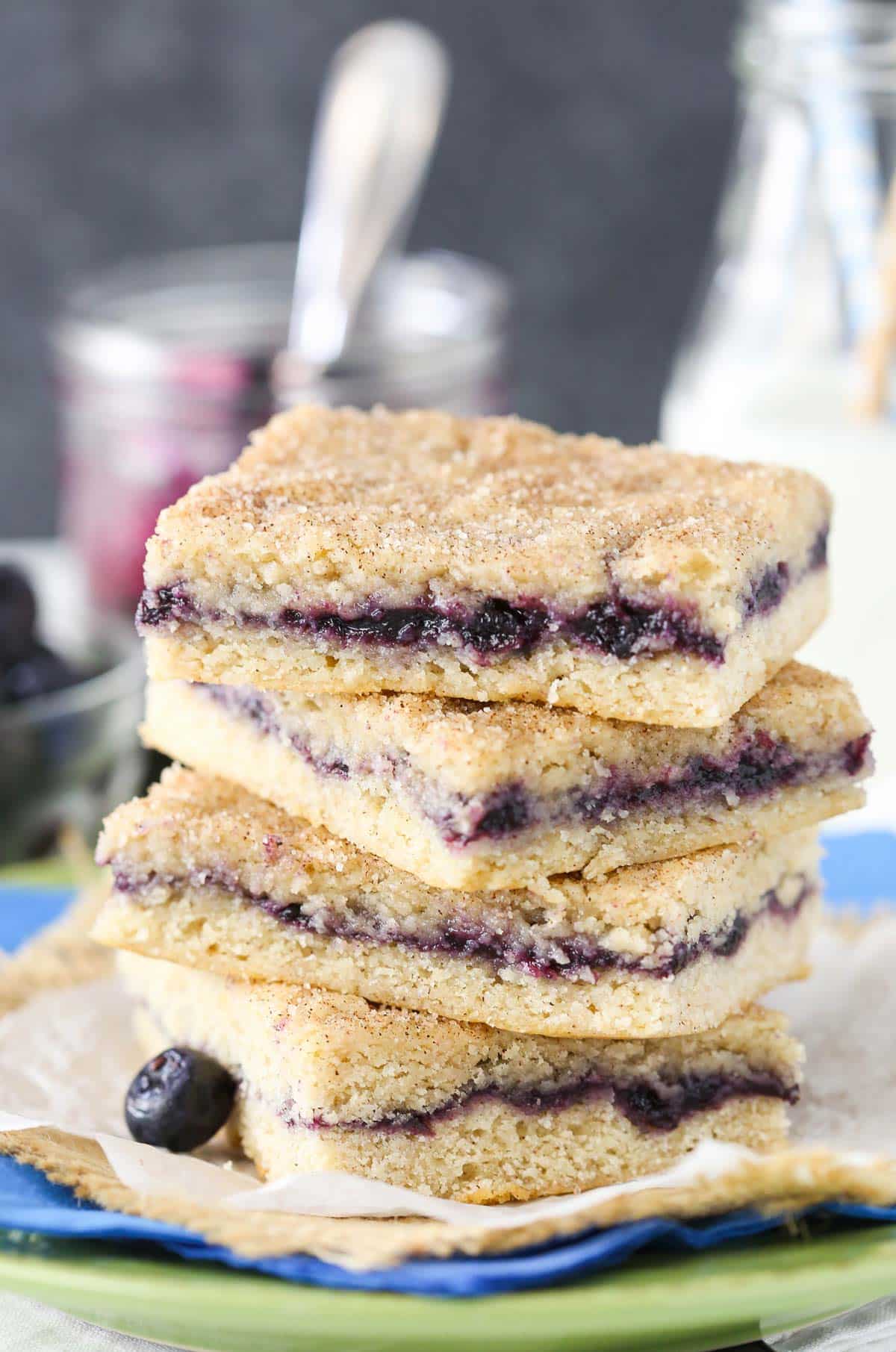 Close up of a stack of 4 blueberry jam cake bars.