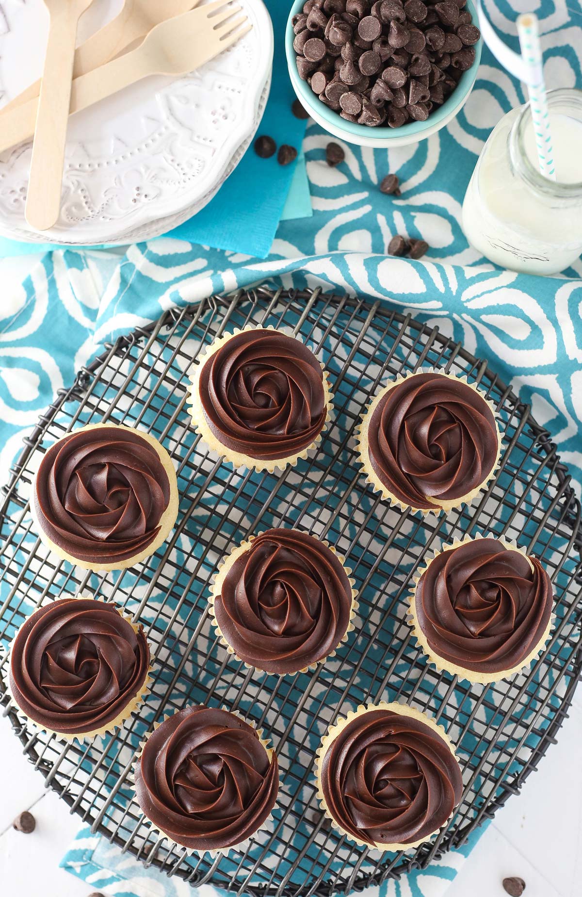 Top view of several Boston cream pie cupcakes on a wire rack.