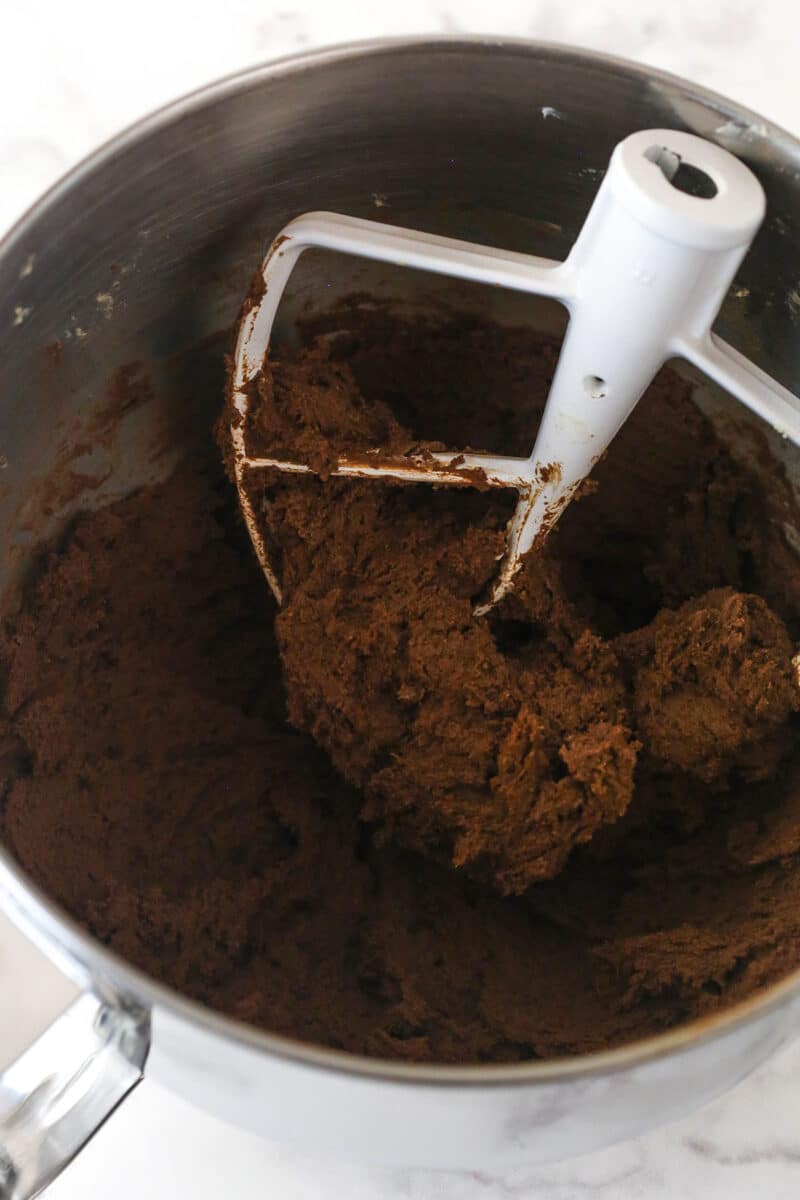 Adding the dry ingredients to chocolate cookie dough.