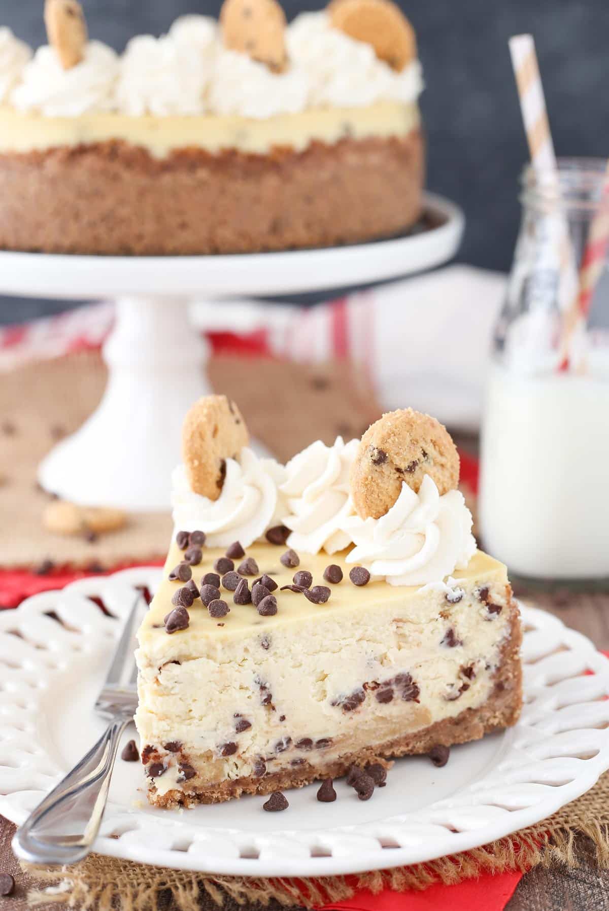 A slice of chocolate chip shortbread cheesecake on a small white plate.