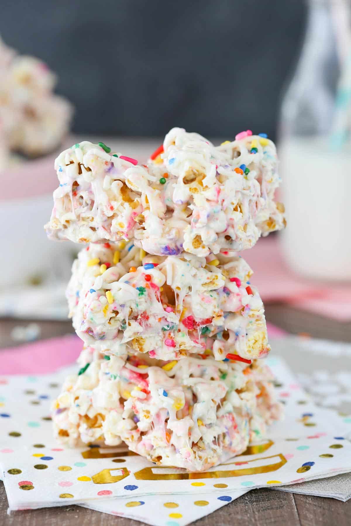 A stack of three funfetti marshmallow popcorn treats.