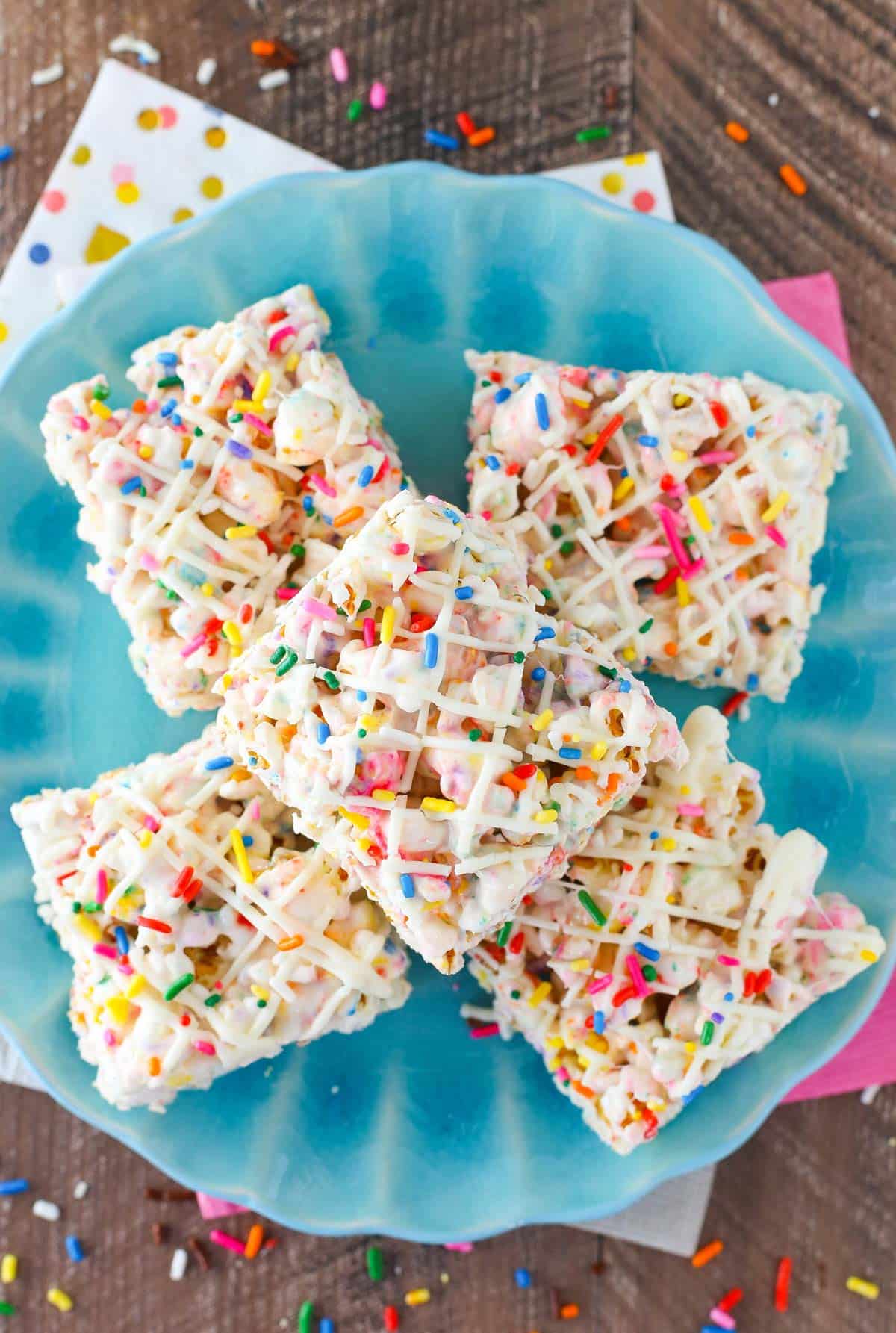 Top view of funfetti marshmallow popcorn treats on top of a light blue plate.