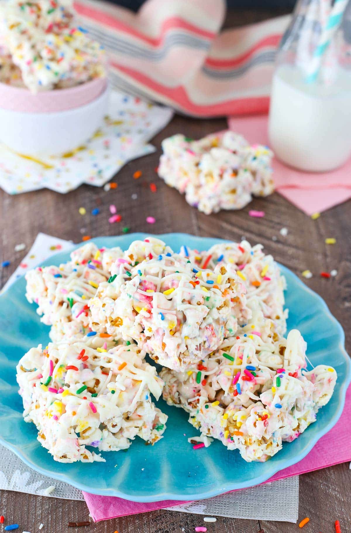 A pile of funfetti marshmallow popcorn treats on a light blue plate.