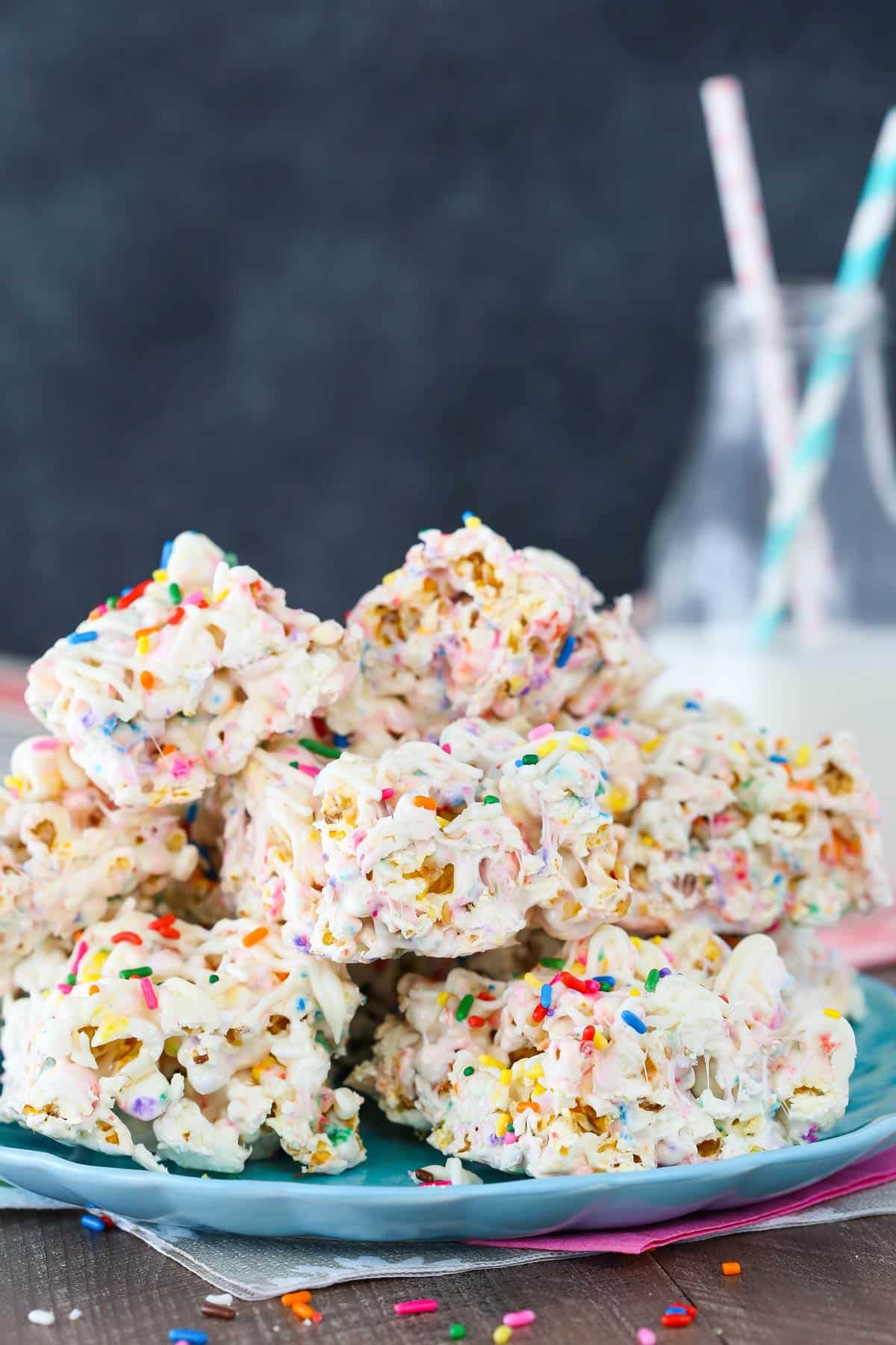 A light blue plate piled with funfetti marshmallow popcorn treats.