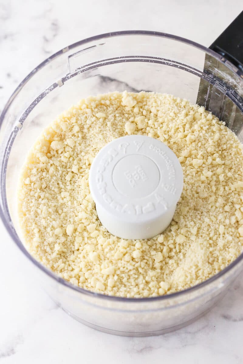 Flour, salt, and butter processed to a sand-like texture in a food processor.
