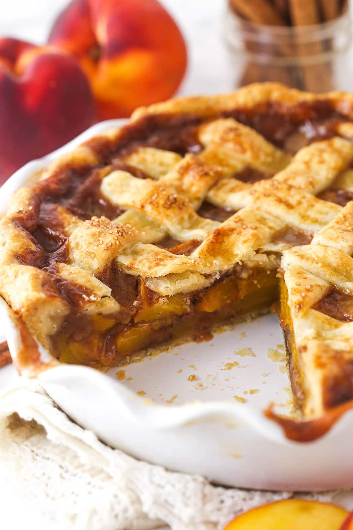 Peach pie with a slice taken out of it.