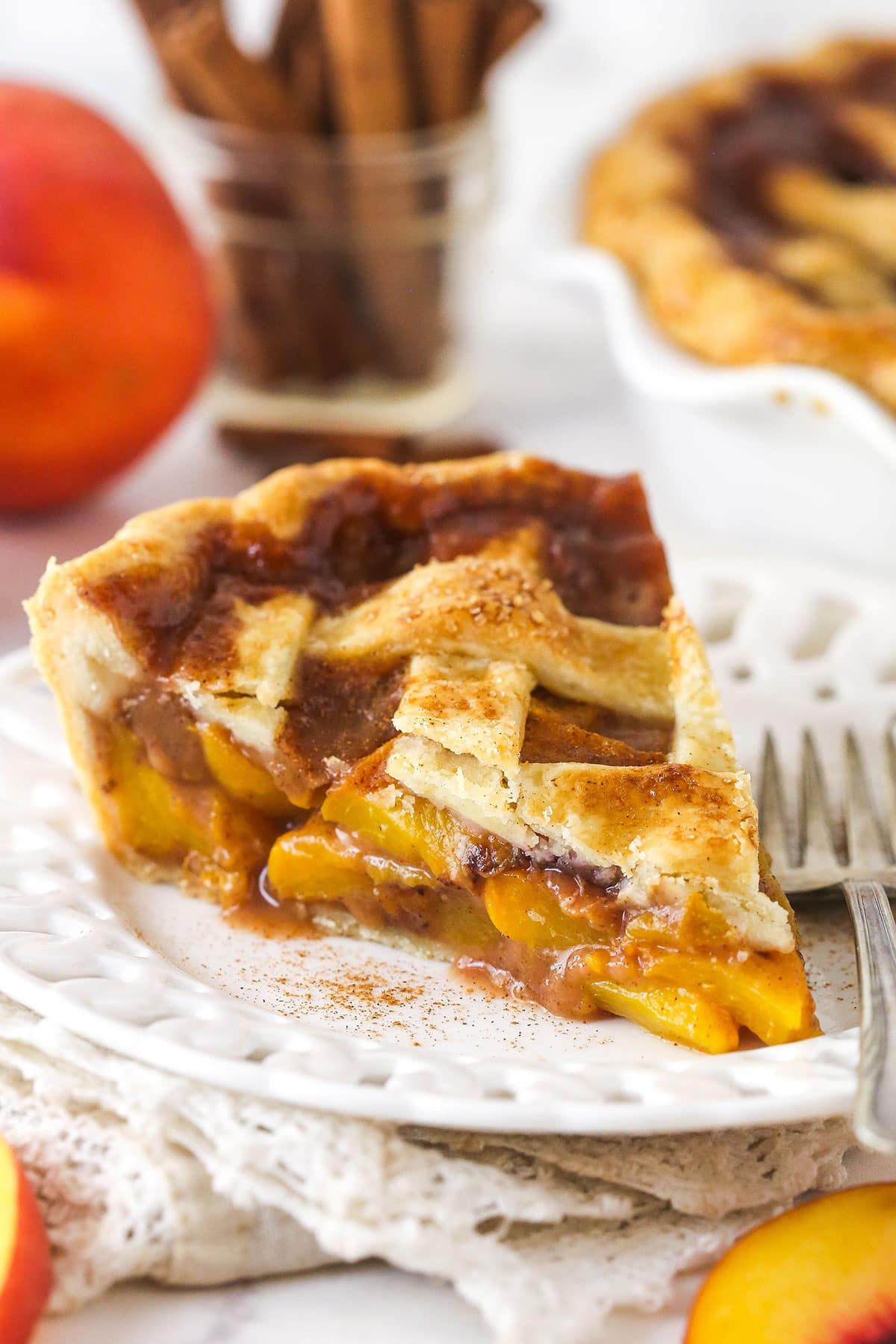A slice of peach pie on a plate.
