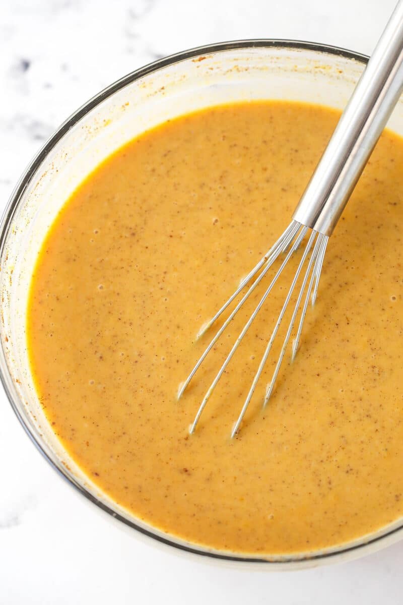 Whisking together the ingredients for the pumpkin custard for pumpkin bread pudding.