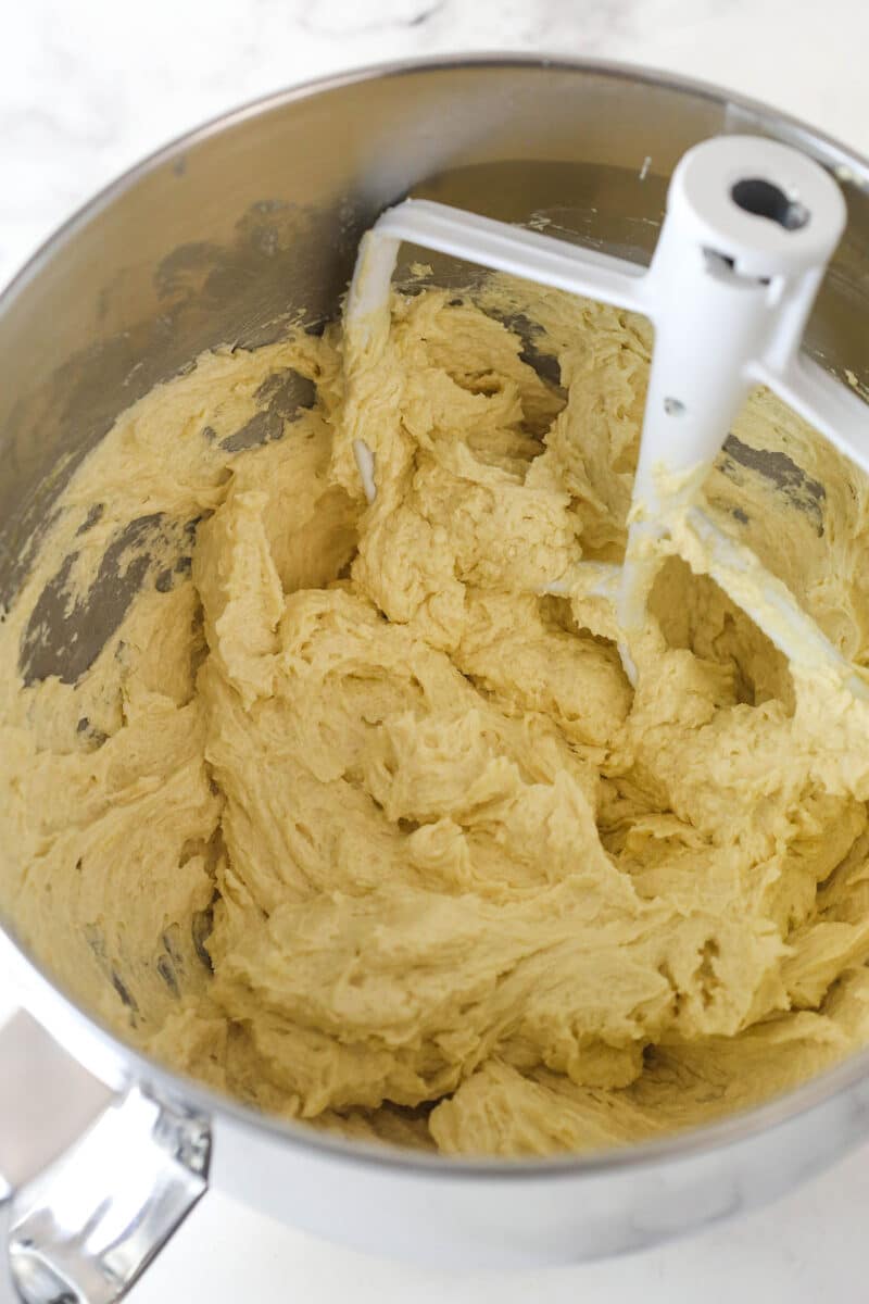 Adding the eggs for pumpkin cake layers.