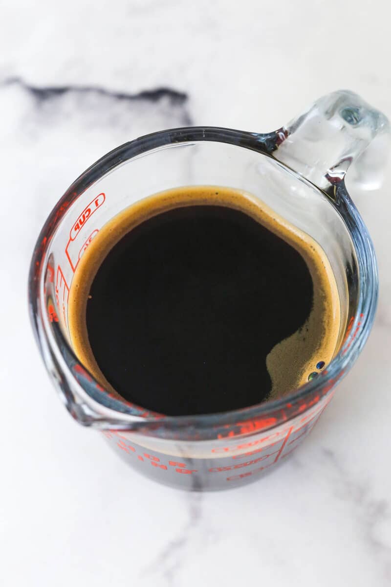 Kahlua-infused coffee in a measuring cup.