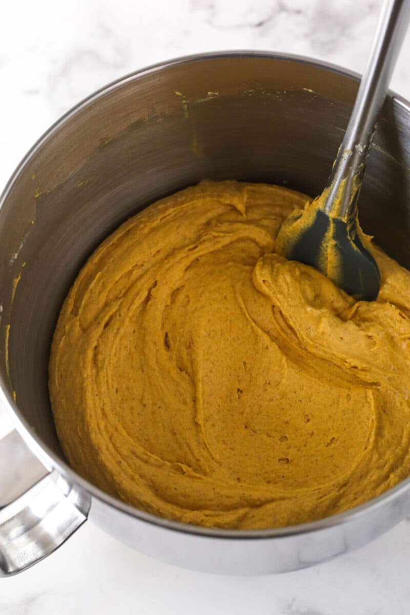 Folding pumpkin puree into cake batter.
