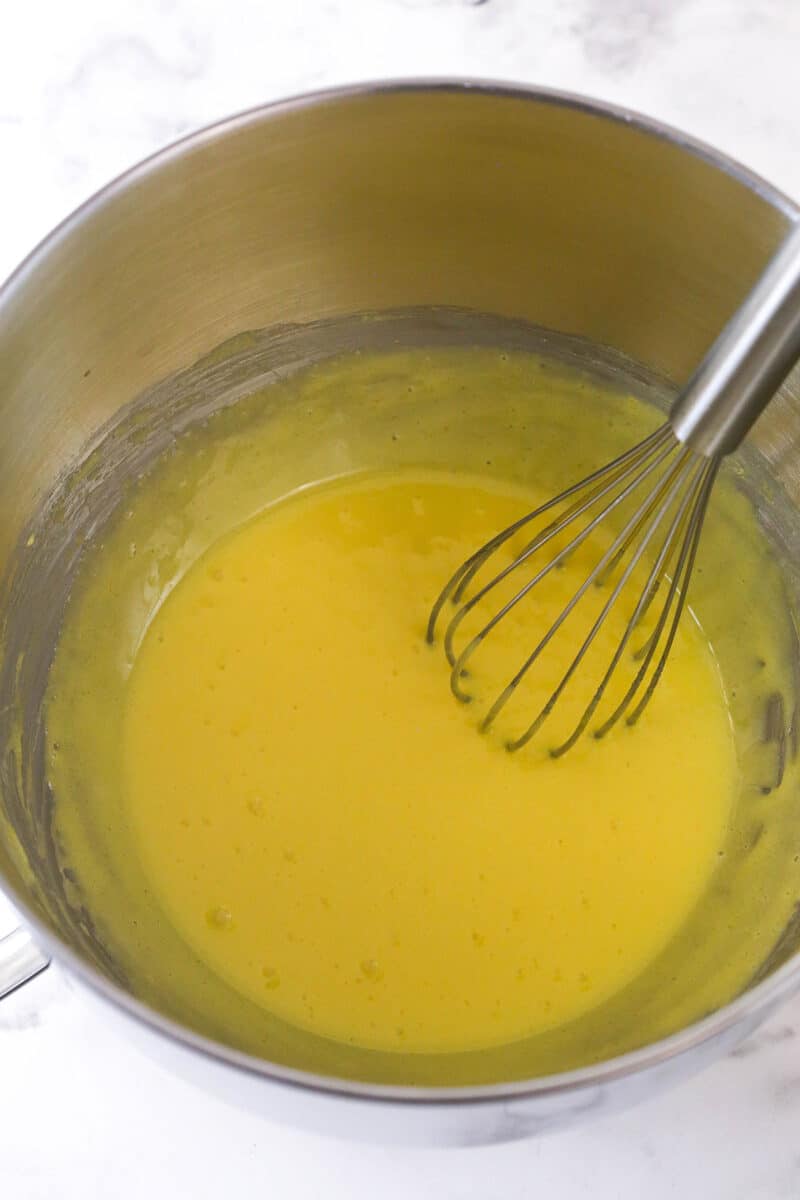 Whisking together egg yolks and sugar for tiramisu filling.