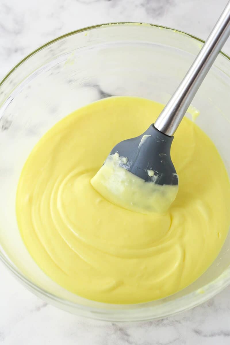Folding mascarpone into cooked and thickened egg yolks and sugar to make tiramisu filling.
