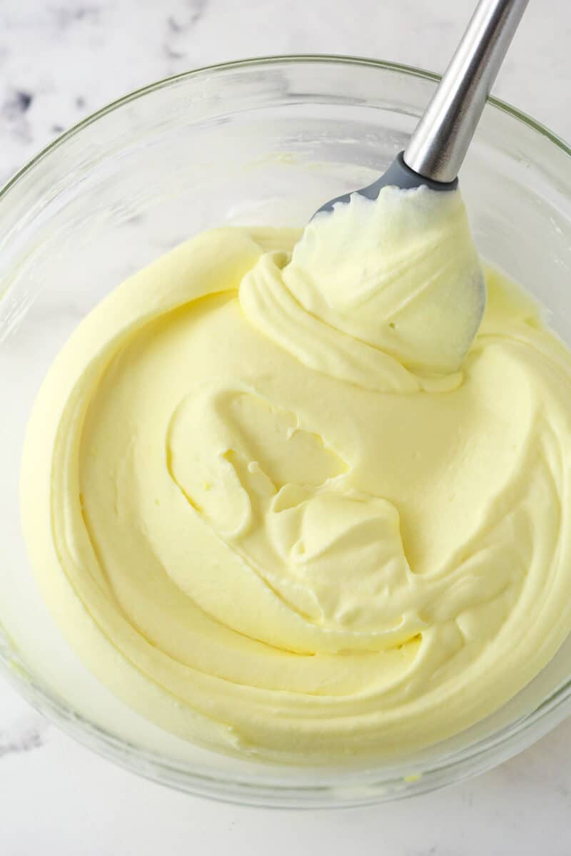 Folding whipped cream into tiramisu filling.