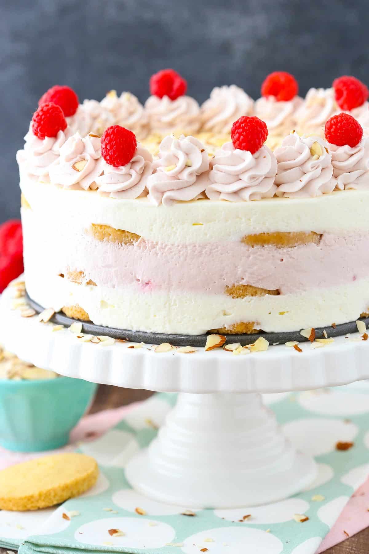 A raspberry almond shortbread icebox cake on a white cake stand.