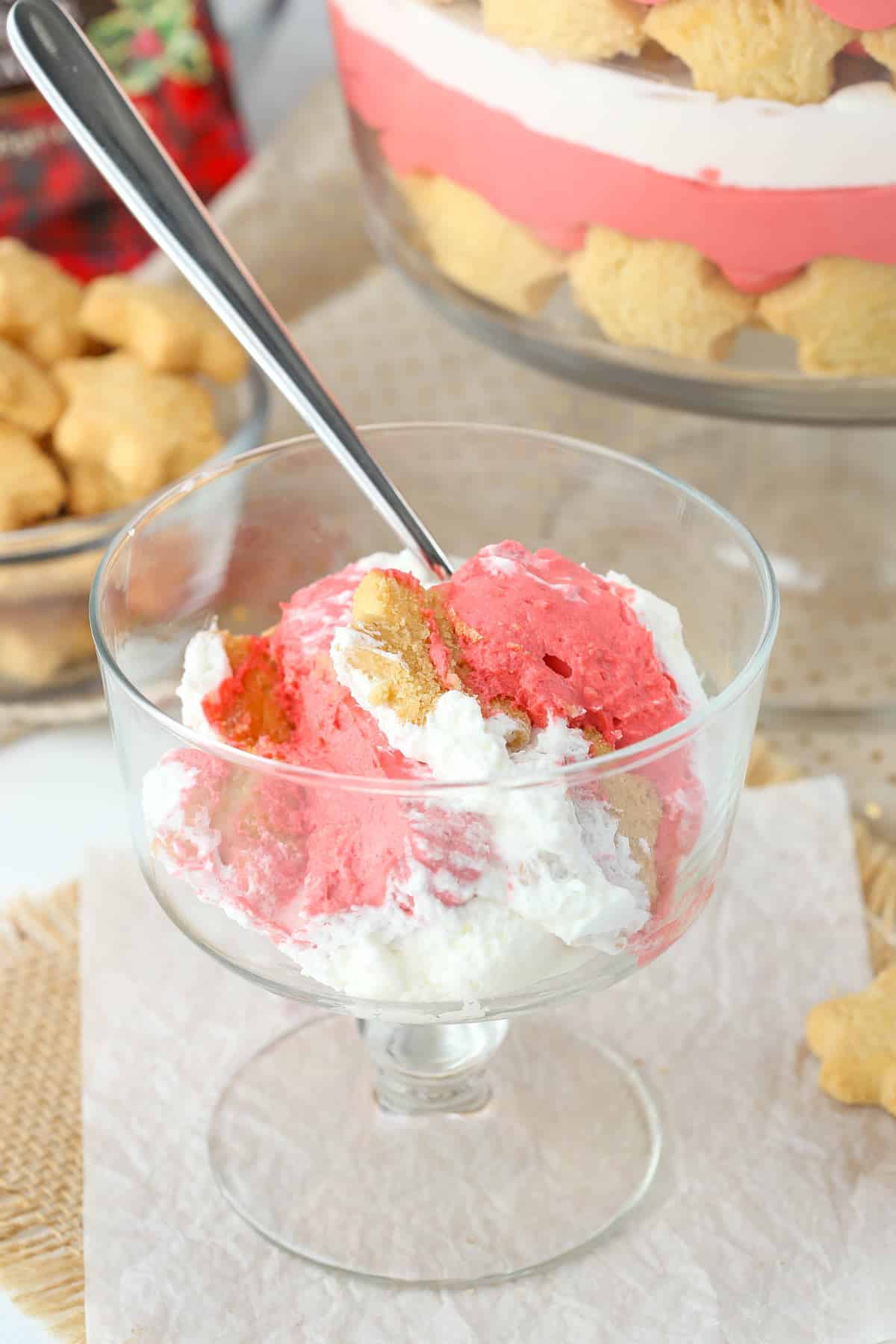 A serving of red velvet shortbread trifle in a small footed dessert cup.